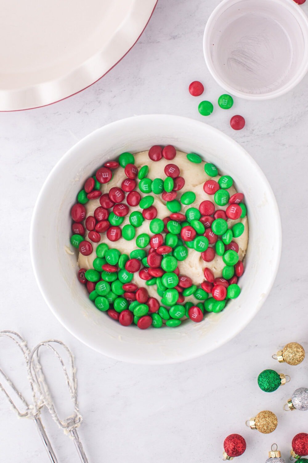 Red and green M&Ms in with sugar cookie dough.