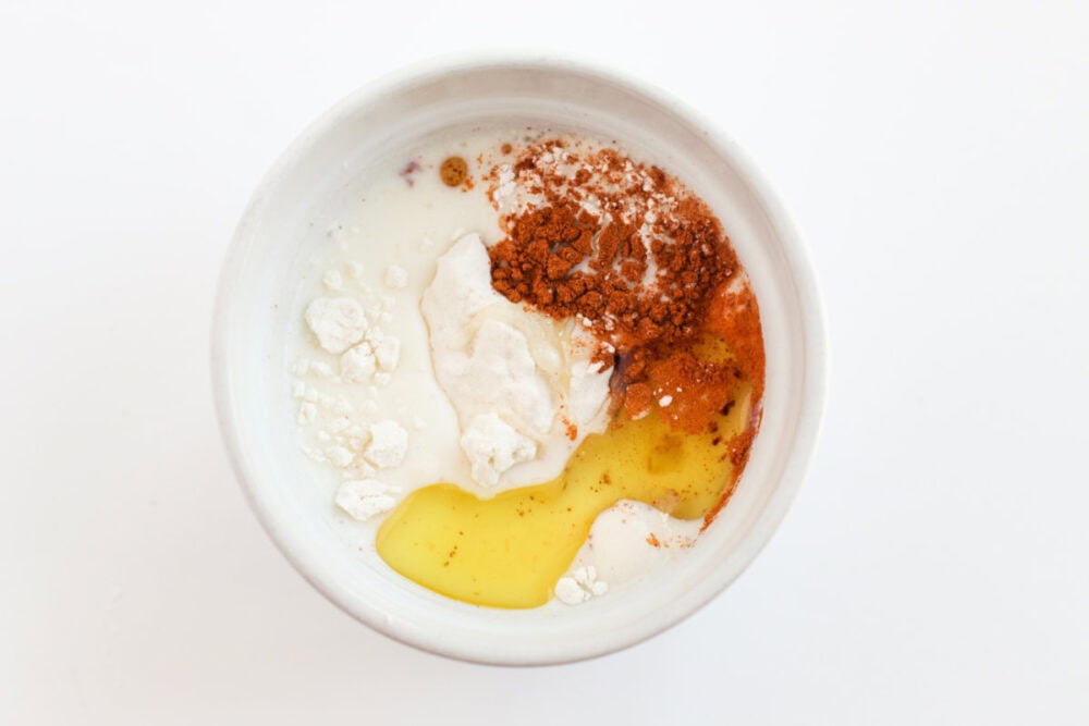 Flour, cinnamon, and egg in a ramekin.