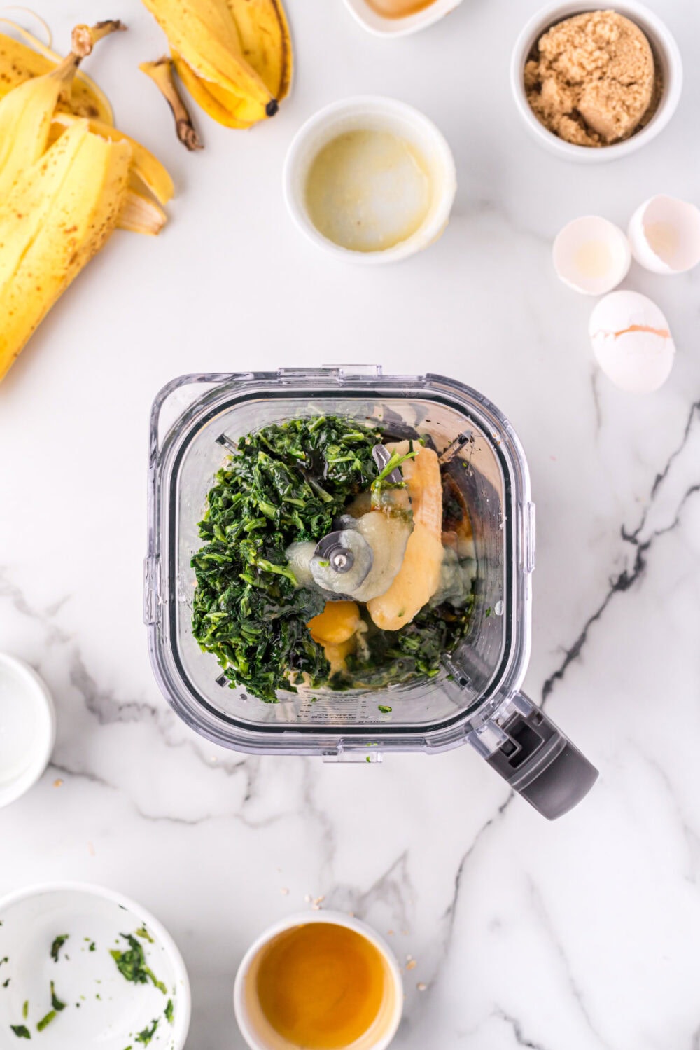Spinach, banana, and other ingredients in a blender. 