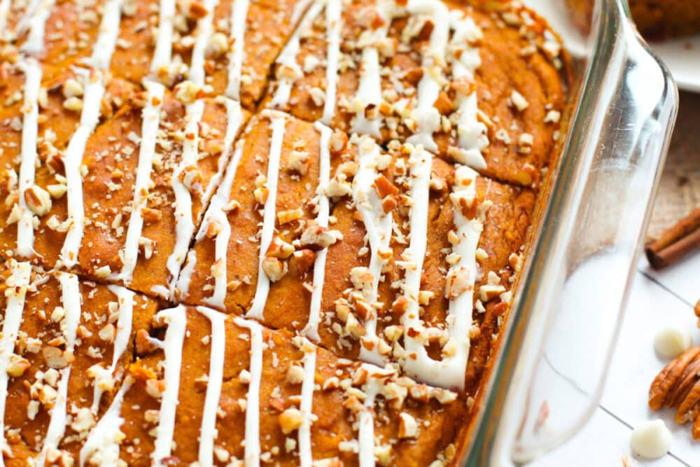 Pumpkin snack cake bars in a clear baking dish. 