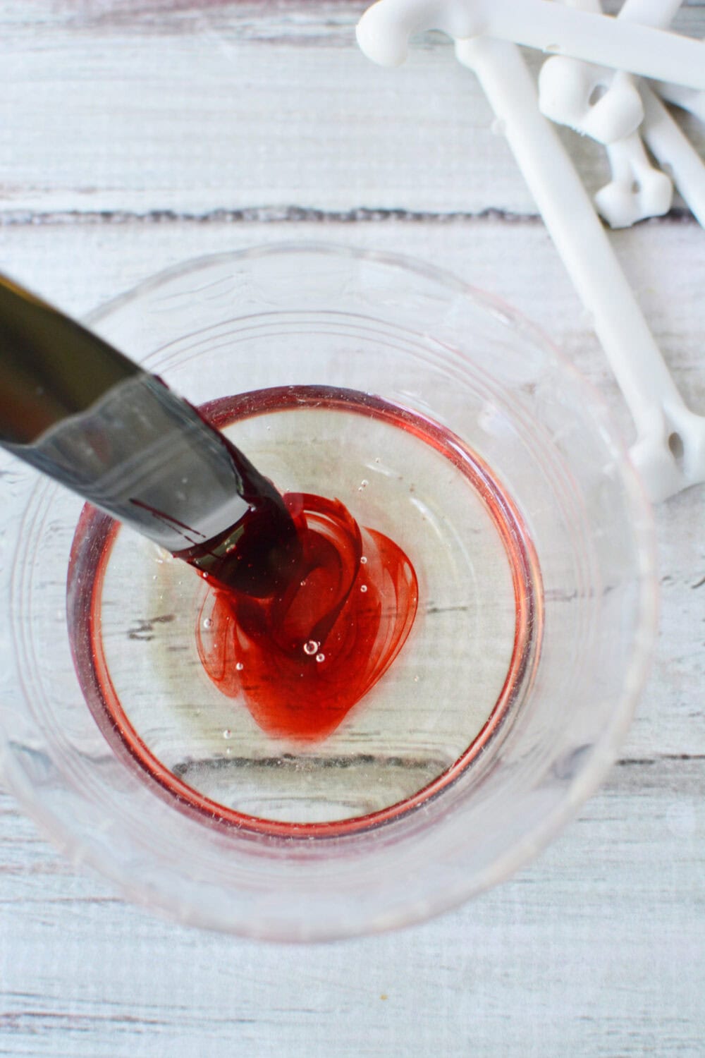 Corn syrup and red food coloring in a bowl. 
