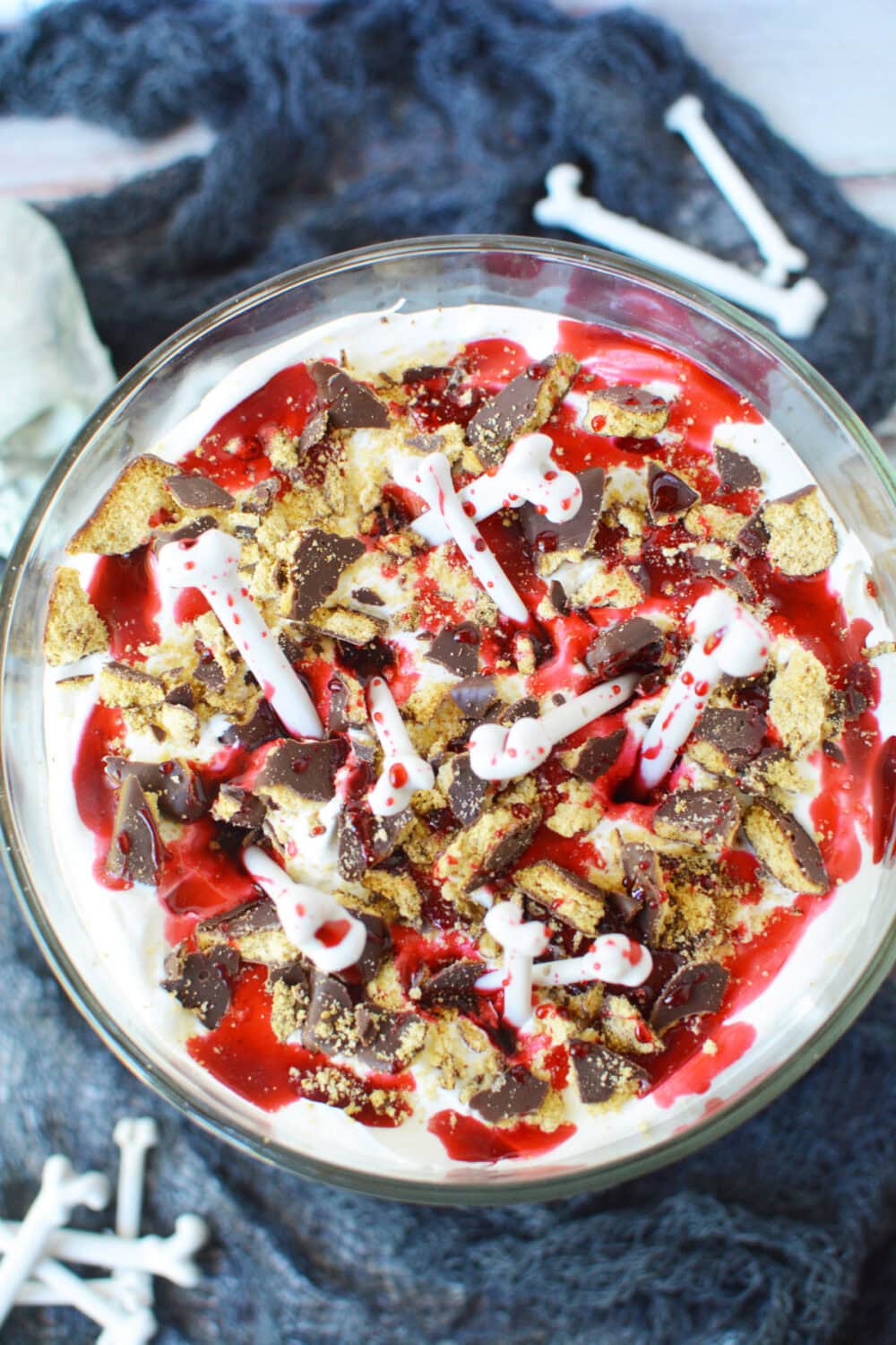 Top of a red velvet trifle with bones for Halloween.