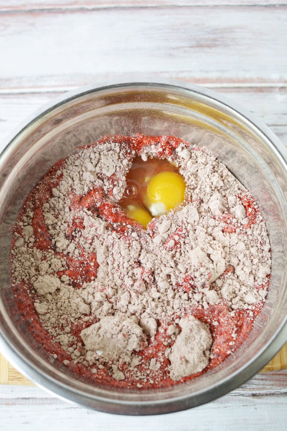 Cake mix with egg in a mixing bowl. 