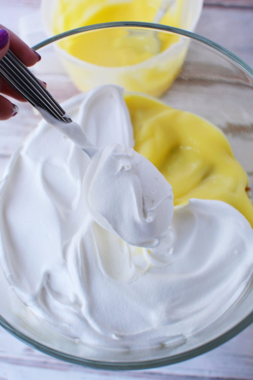 Whipped topping in a layer of a trifle on top of pudding. 