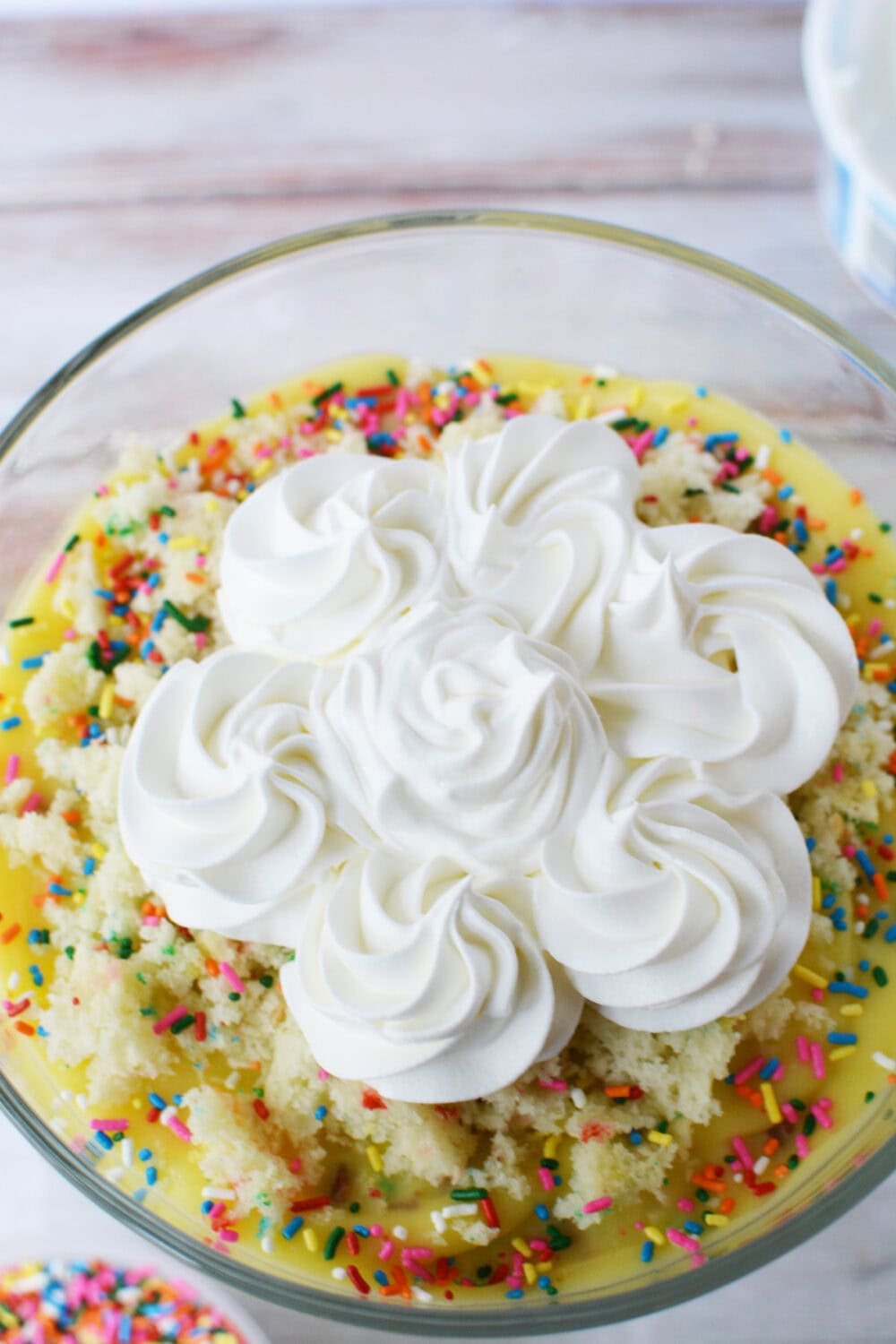 Whipped topping on top of a birthday trifle. 