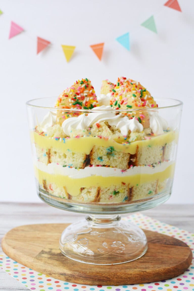 Layers of funfetti cake, cookies, pudding, and whipped topping in a trifle.