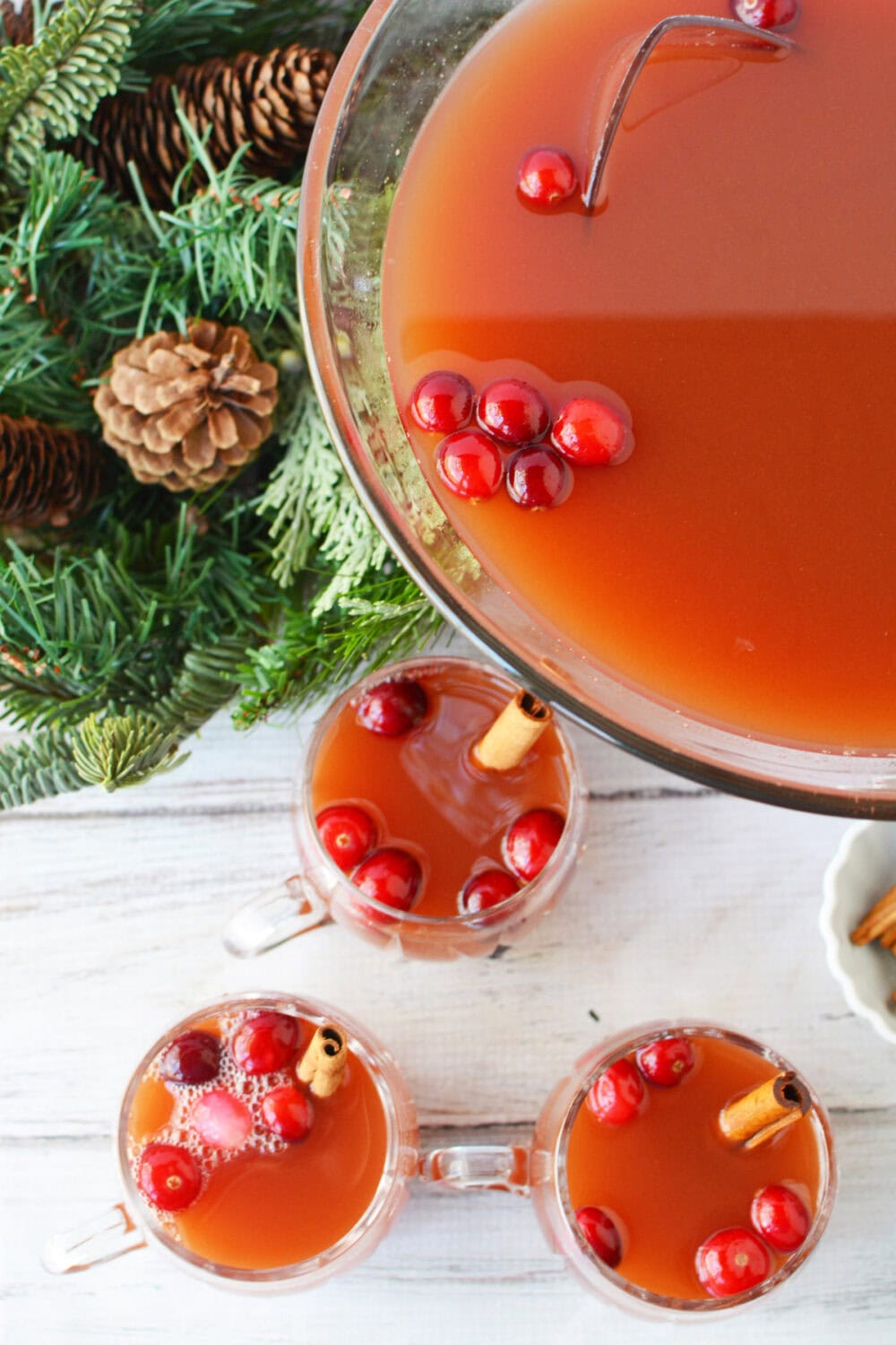 Glasses of punch next to the punch bowl. 