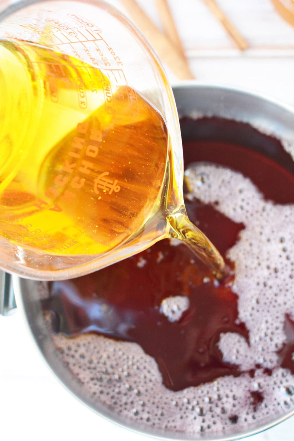 Pouring apple juice into a pan. 