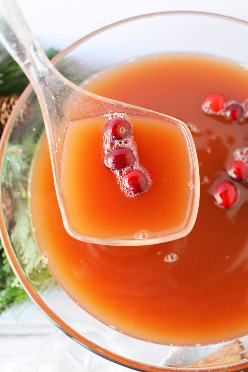 Ladle of punch above the bowl. 