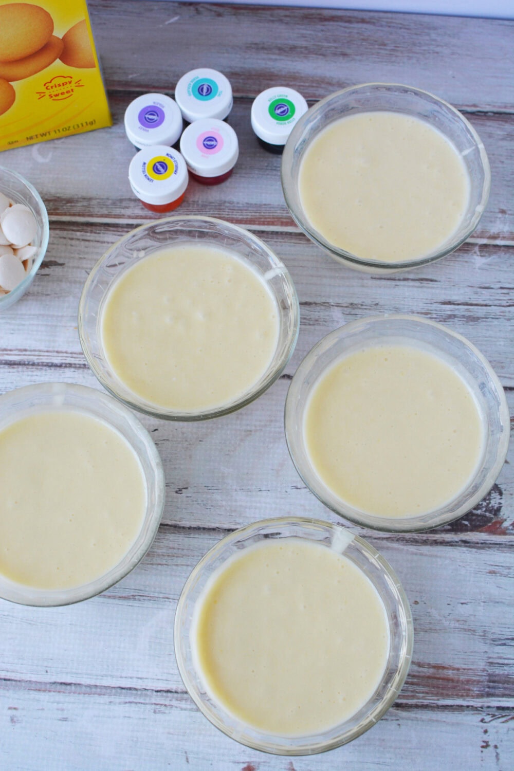 Cake batter in five bowls. 