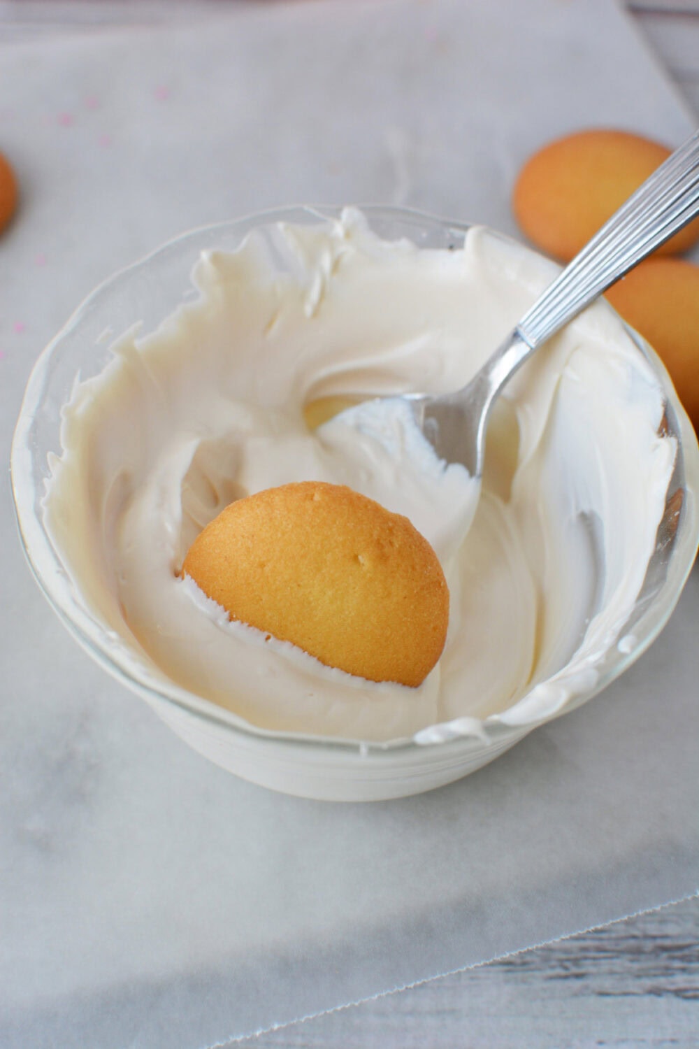 Dipping a nilla wafer into white candy melts. 