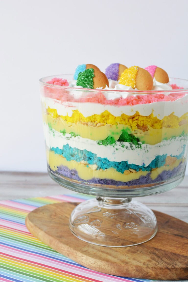 Rainbow trifle topped with colored cookies.