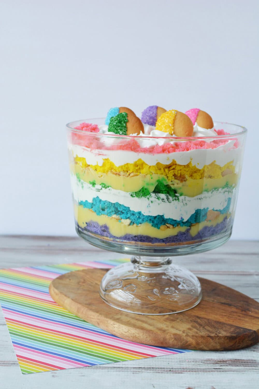 Rainbow trifle in a bowl on a board. 