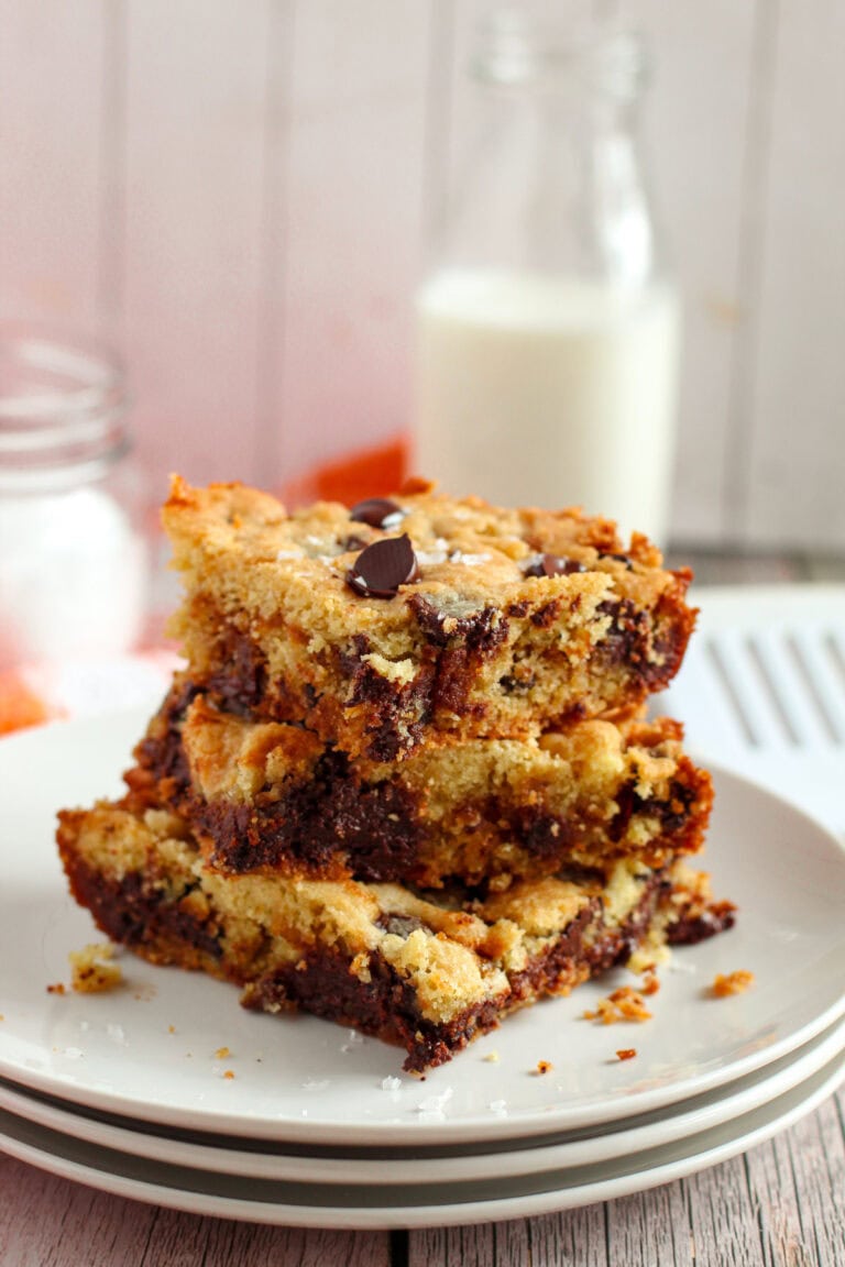 Stack of sliced caramel chocolate cookie bars on a plate.