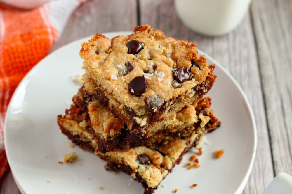 Salted caramel chocolate chip cookies bars stacked on a plate. 
