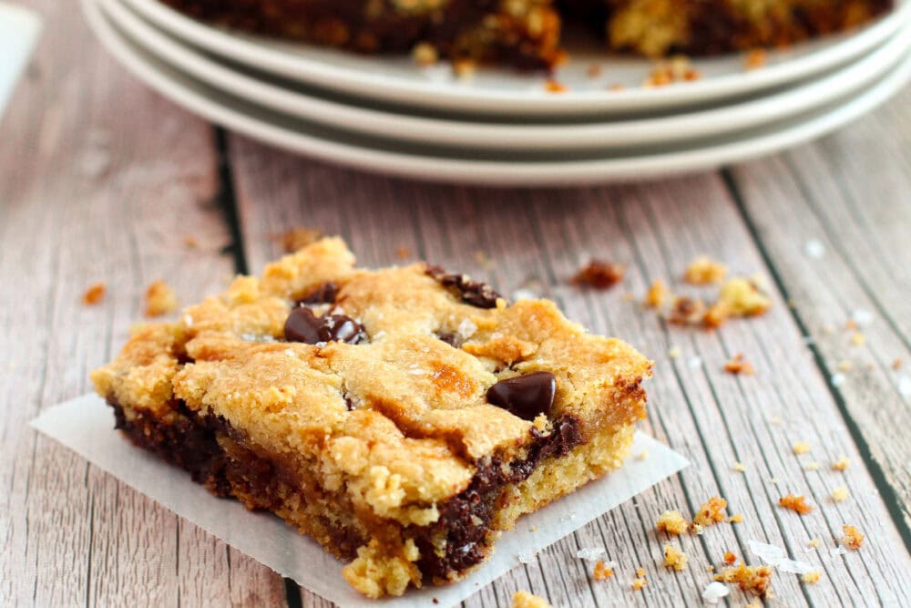 Sliced caramel chocolate chip cookie bar on a table.
