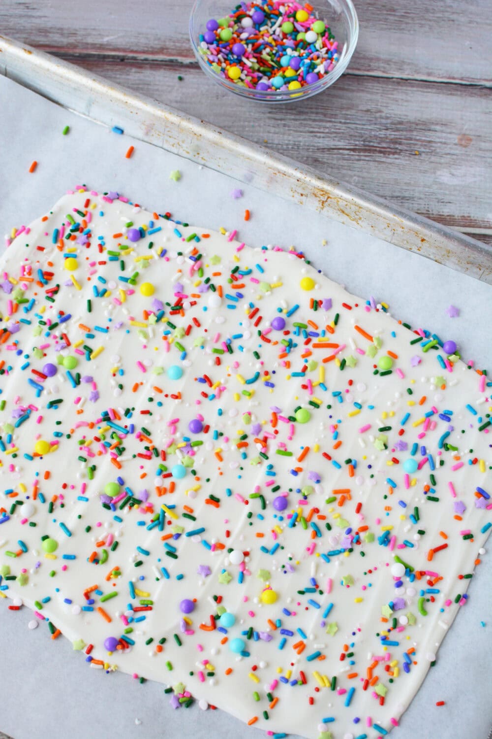 Confetti bark candy on a baking sheet ready to set.