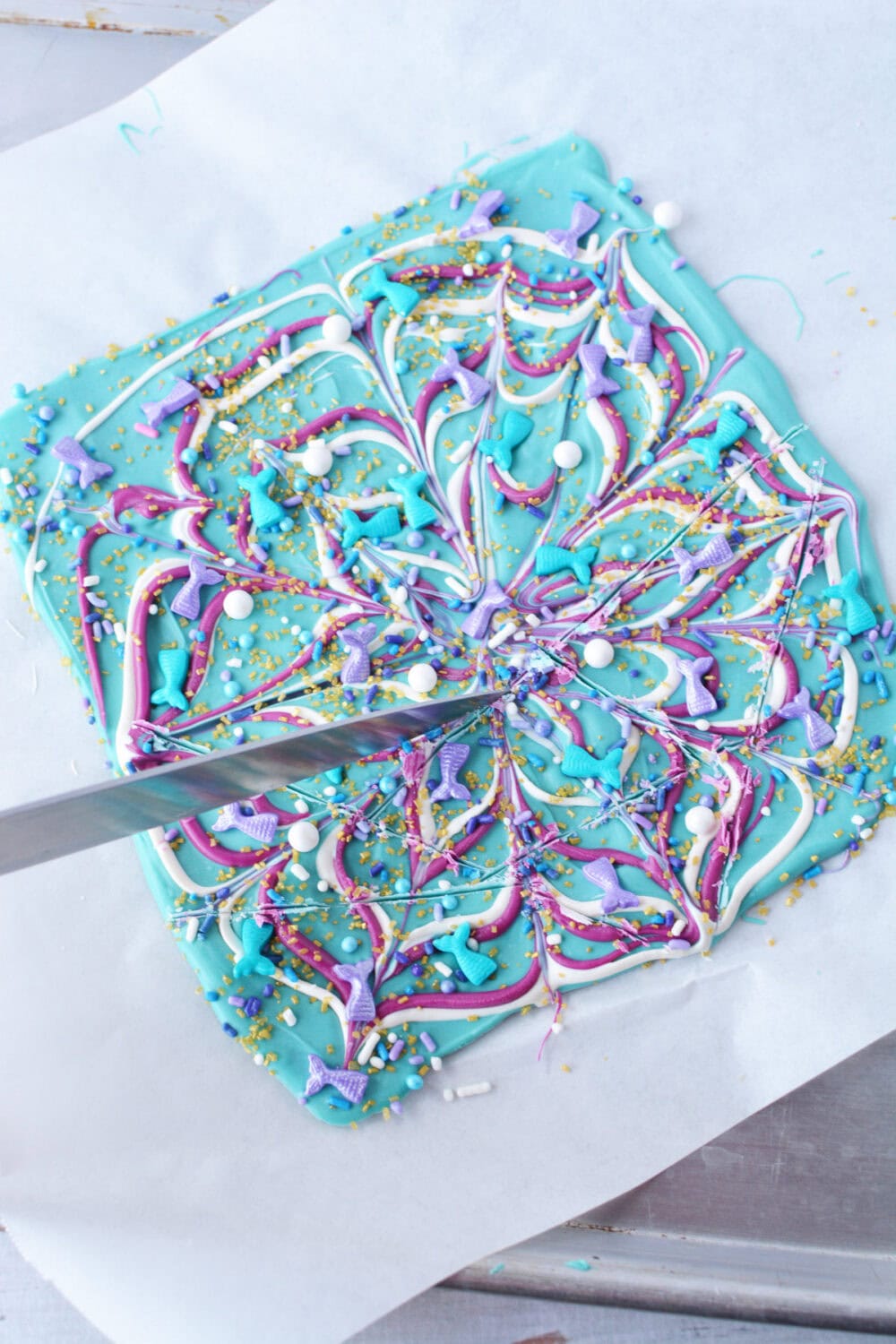 Cutting mermaid candy bark. 