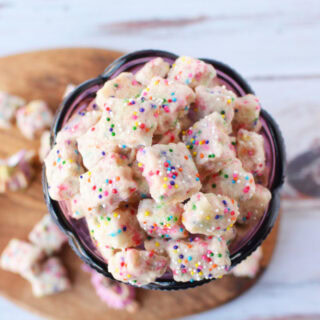A purple chalice filled with tiny shortbread bites with rainbow sprinkles.