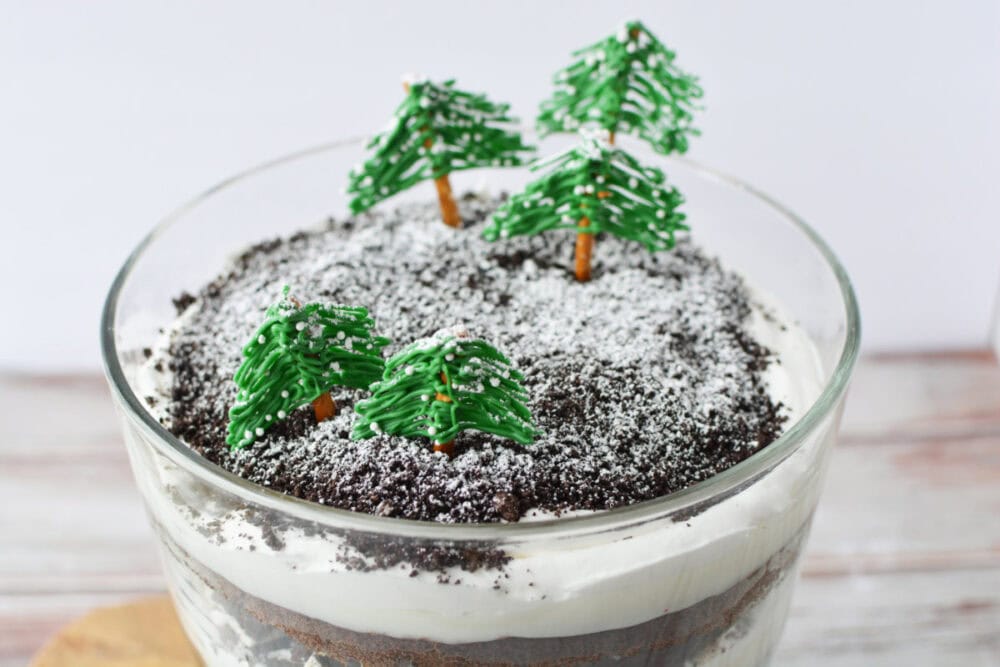 Chocolate winter trifle topped with edible trees and powdered sugar to look like snow. 