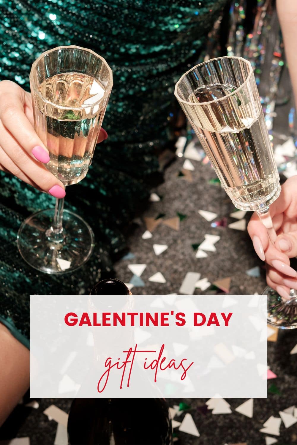 Two girls with champagne glasses and sparkly dresses on.