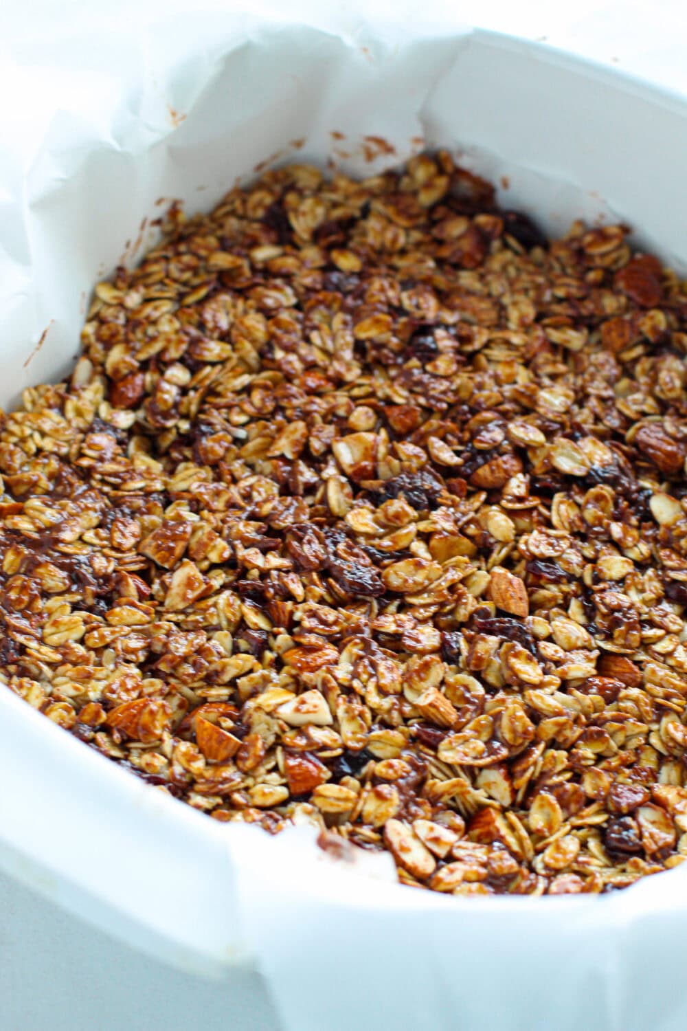 Chocolate cherry granola bar mixture in a pan.
