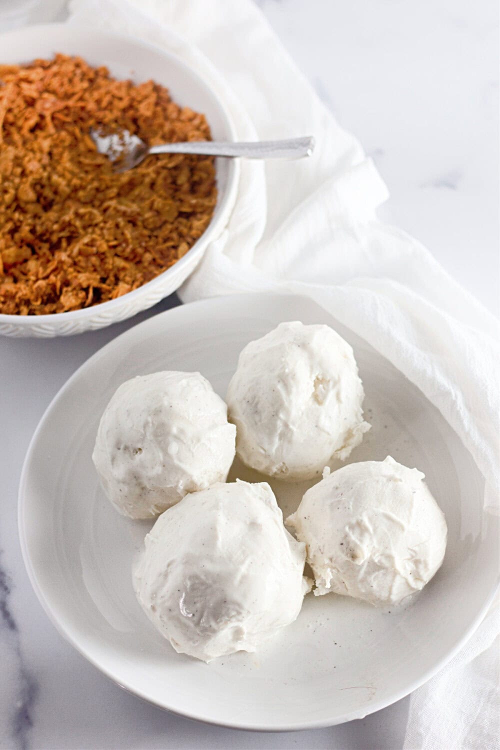 Ice cream balls on a plate.