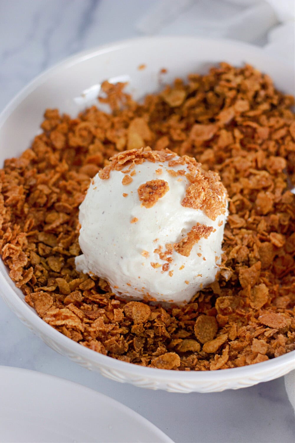 Coating ice cream in corn flakes.