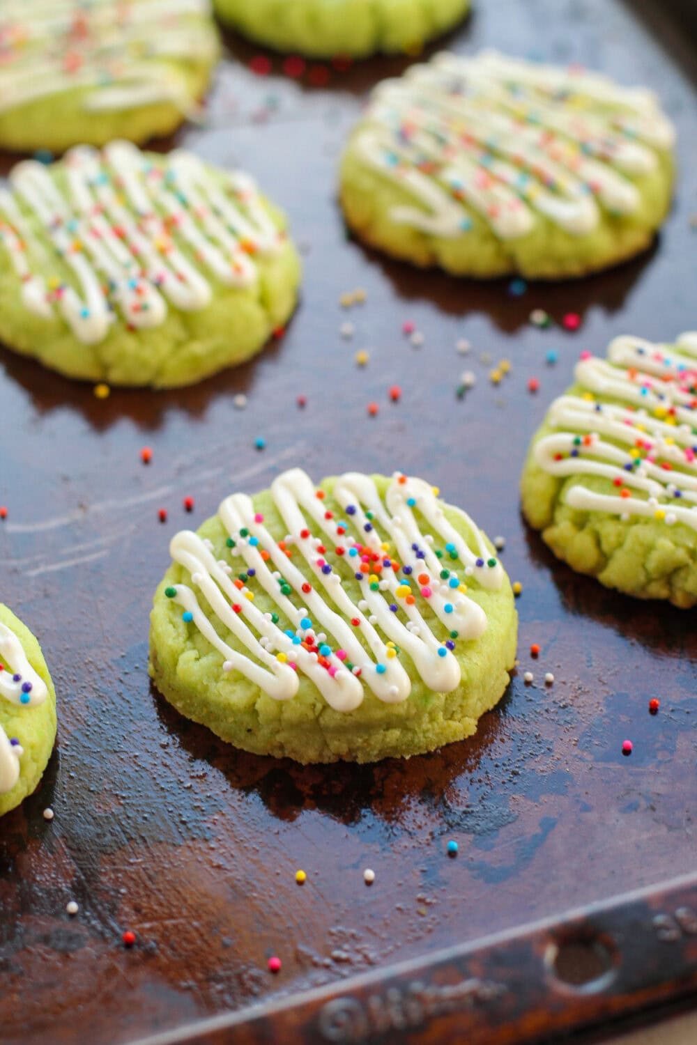 Nonpareils sprinkled onto lime cookies.