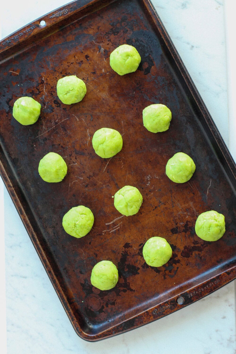 Cake mix dough balls on a baking sheet.
