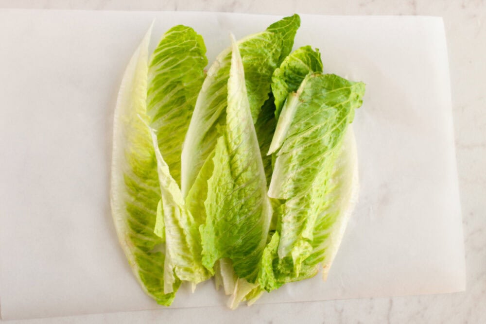 Lettuce leaves on parchment paper.