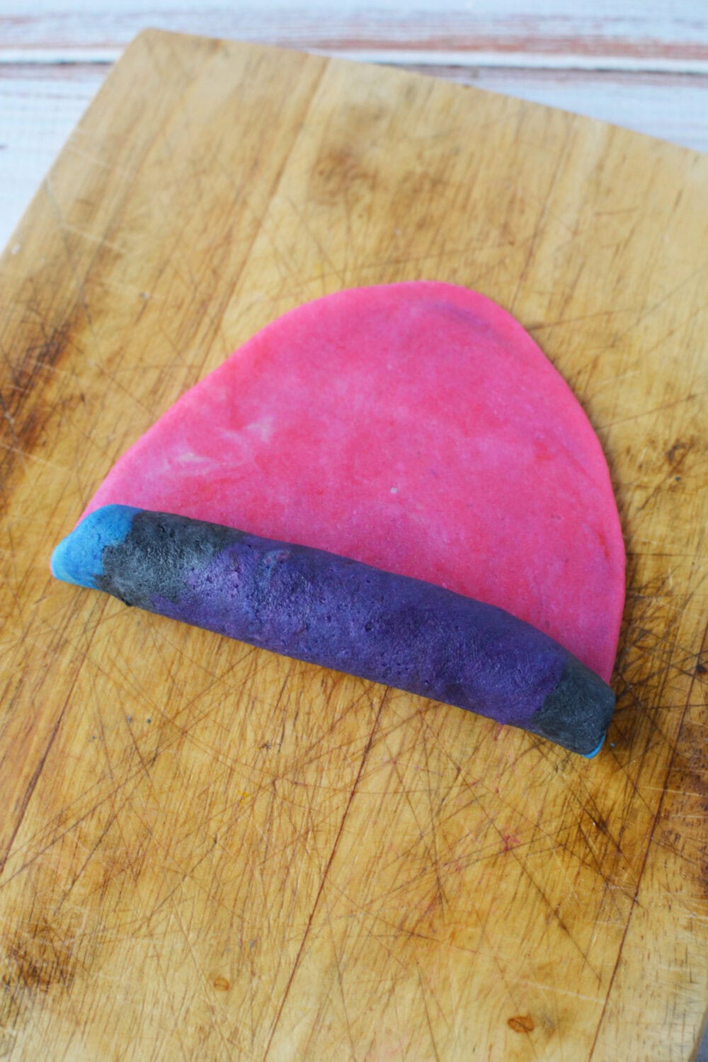 Rolling colored cookie dough. 