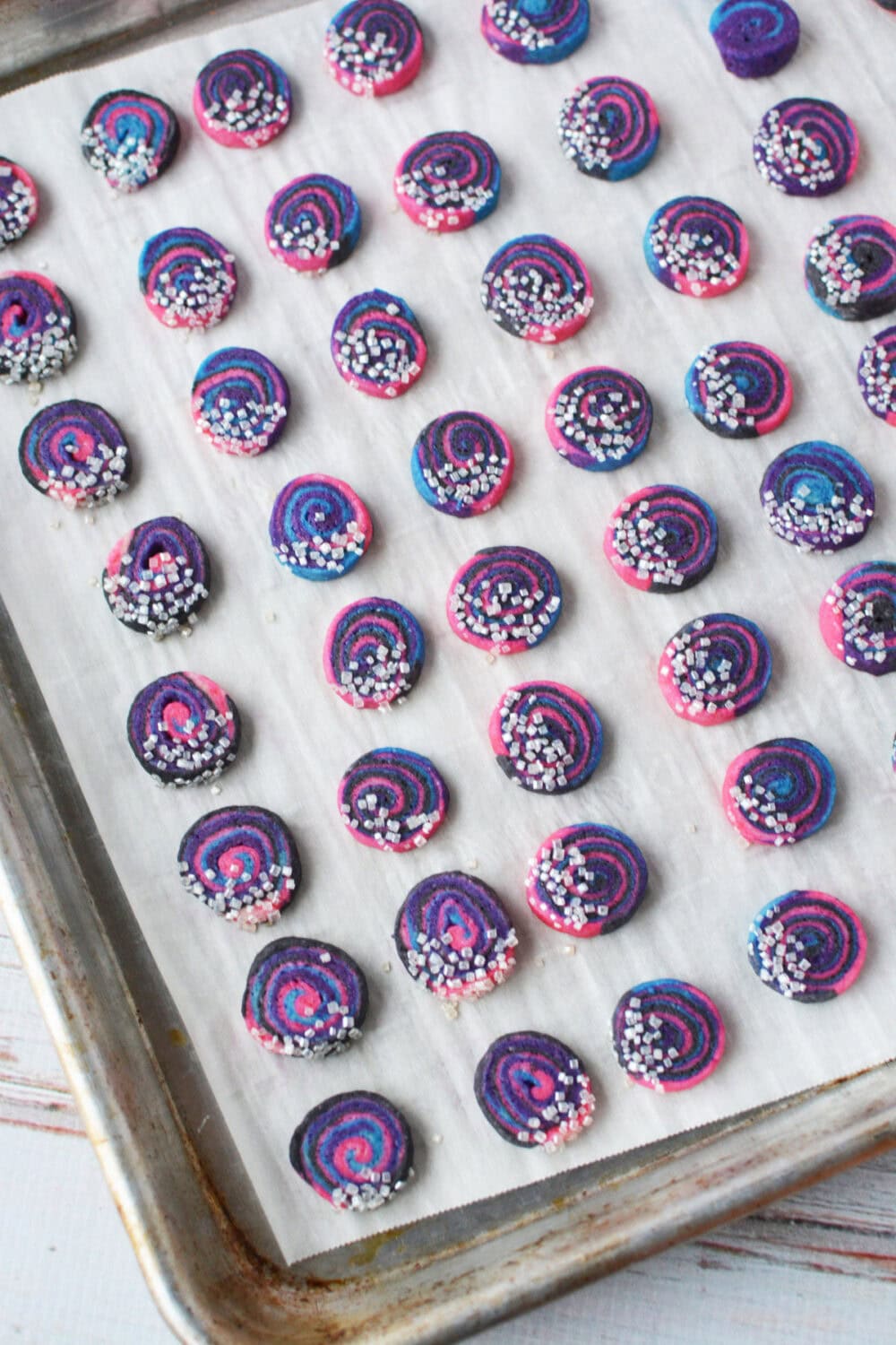 Mini space cookies on a cookie sheet. 