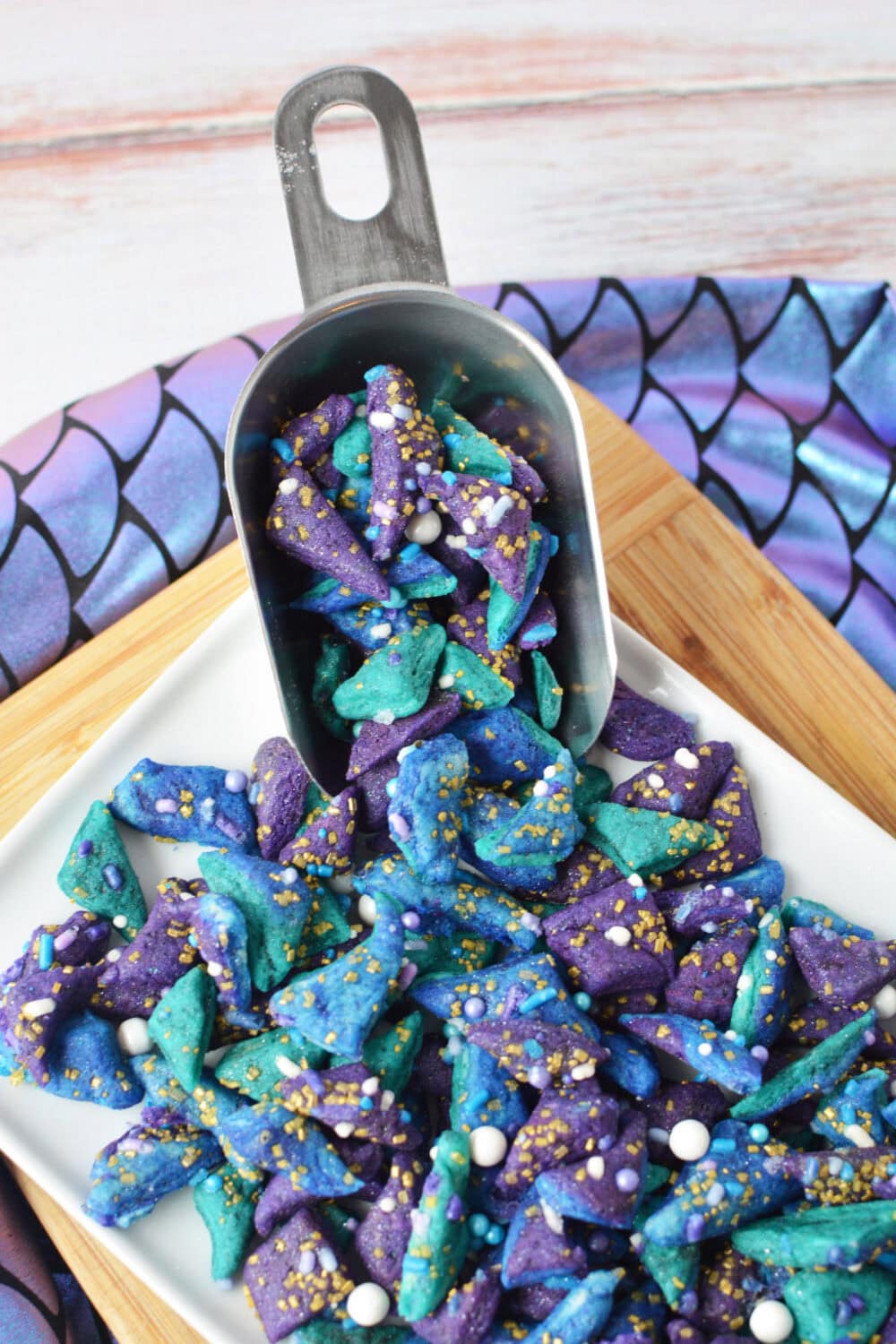 A scooper with mermaid mini cookies on a tray.