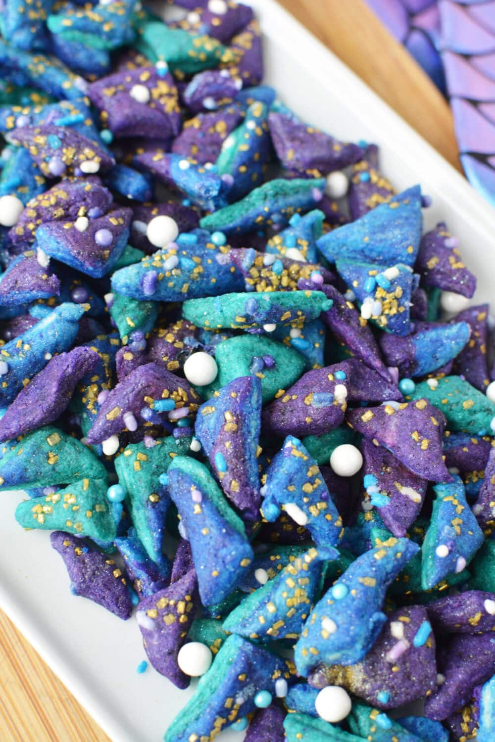 A pile of teeny tiny mermaid cookies on a tray.