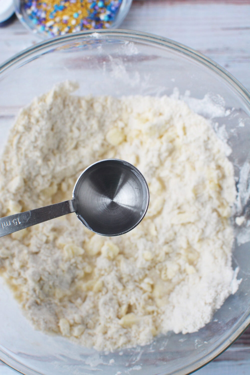 Adding water to dough.