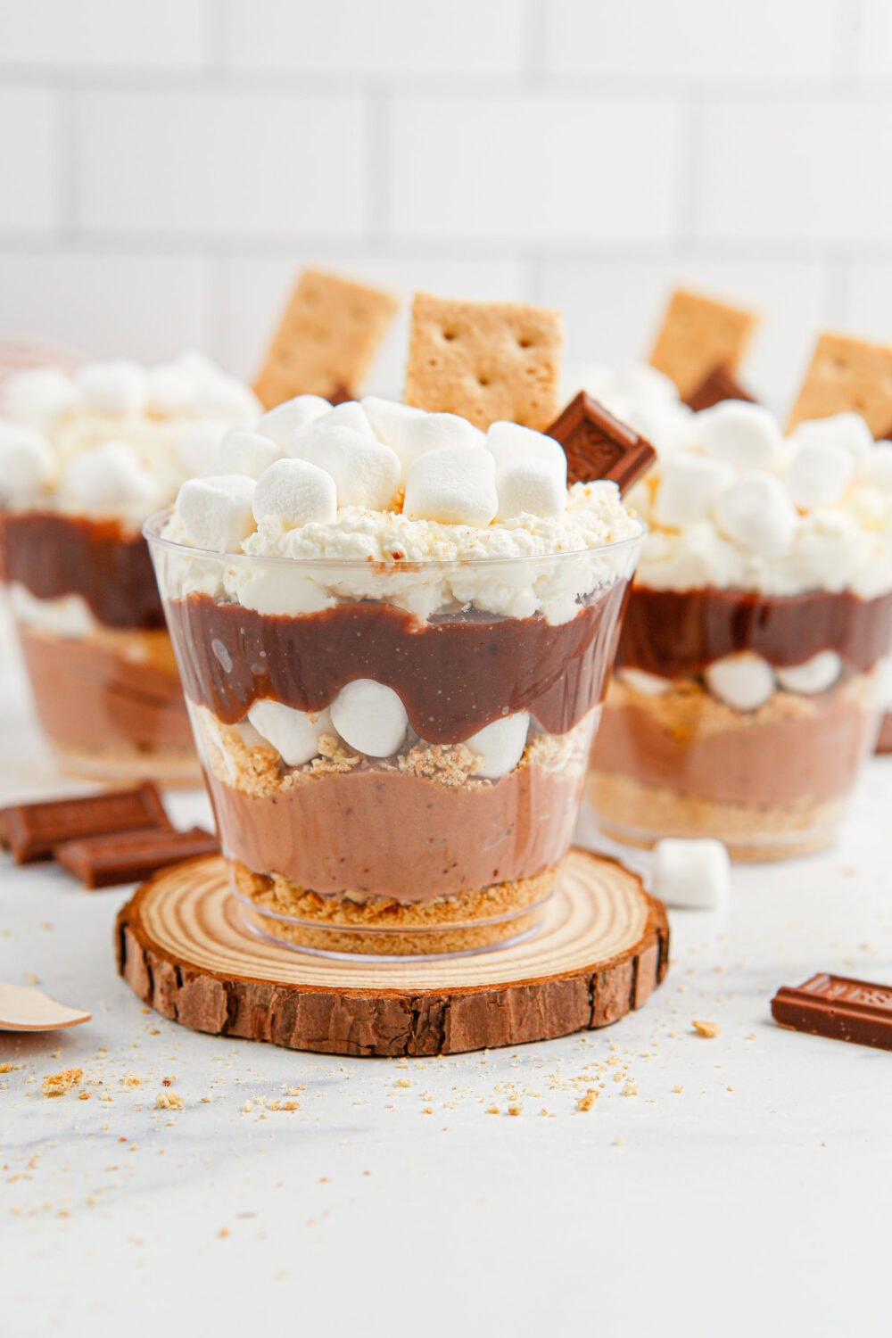 Layers of pudding, marshmallow, whipped cream, and graham crackers in little cups.
