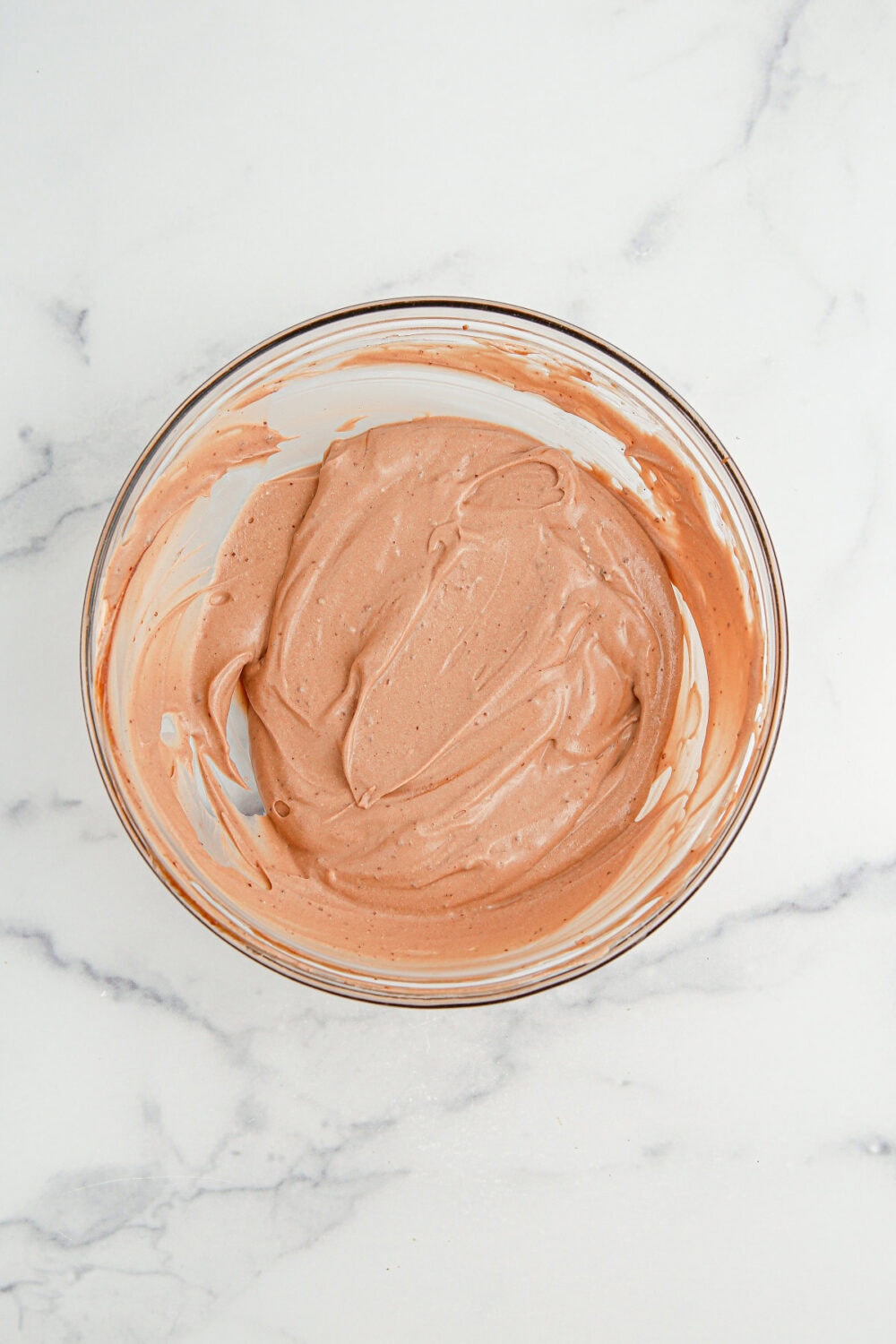Chocolate pudding and whipped cream mixed in a bowl.
