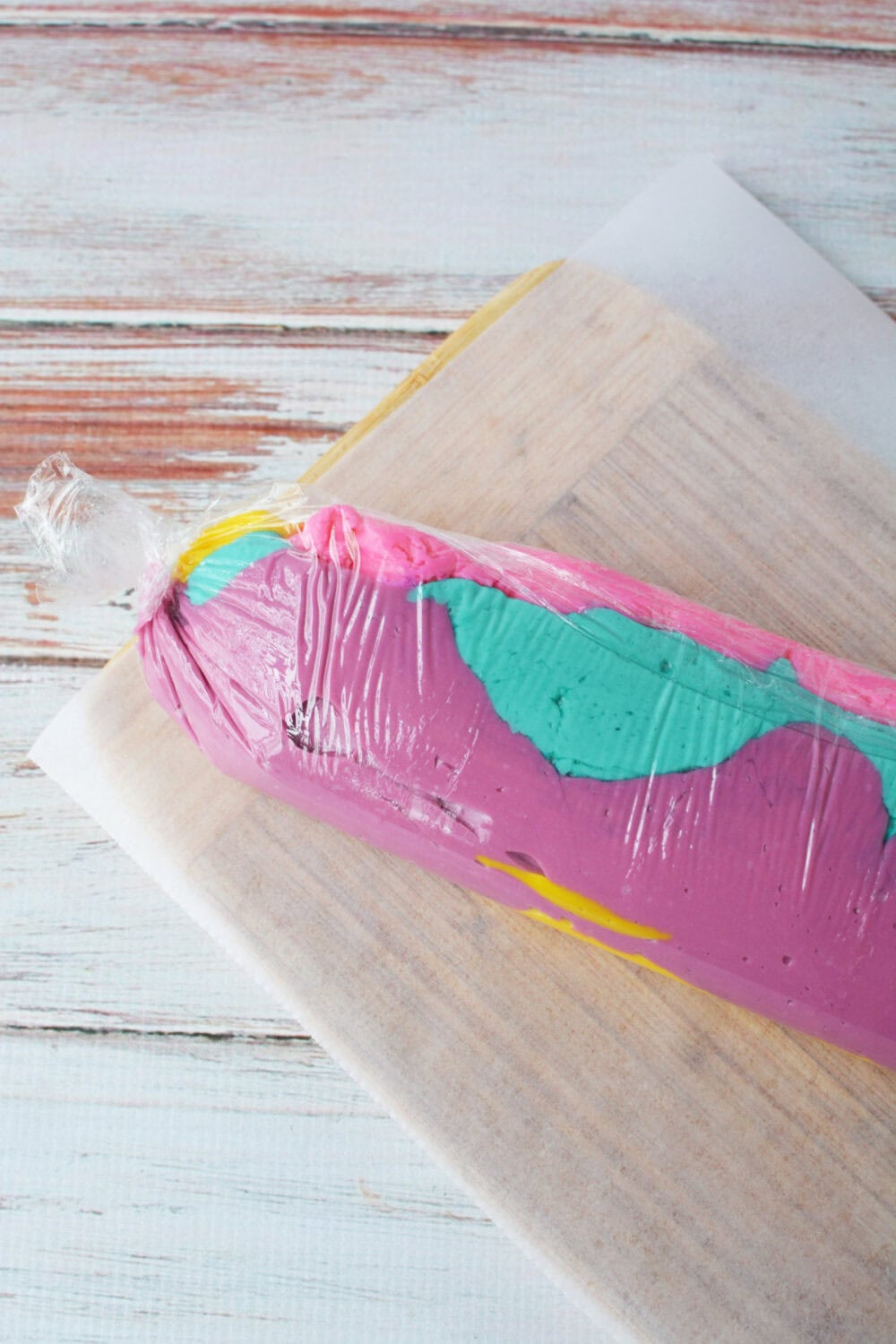 Fudge in different colors rolled in wrap.