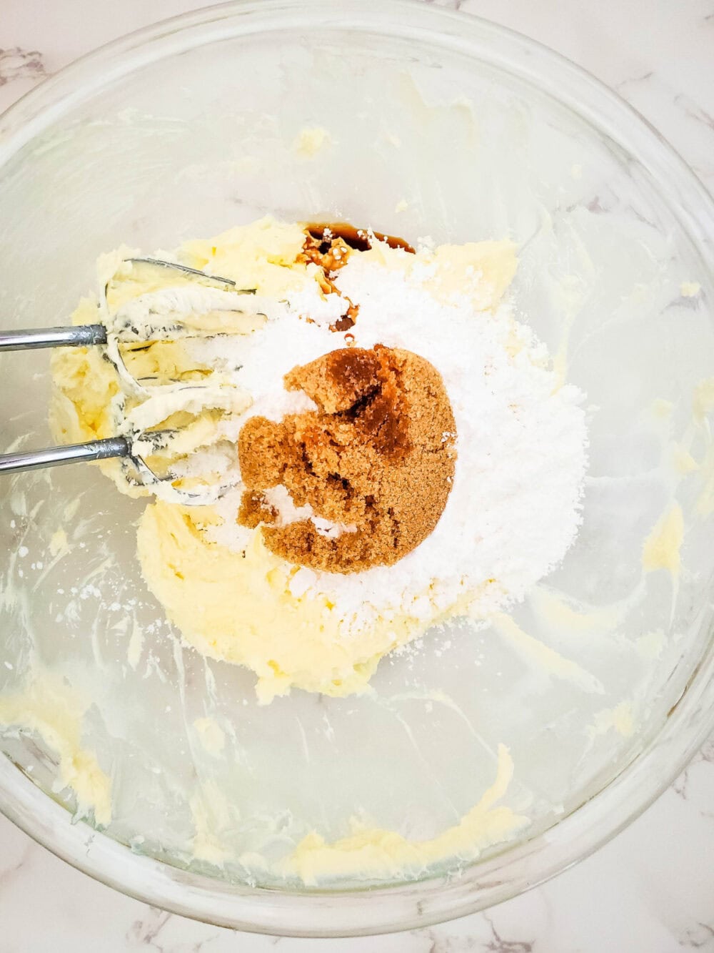 Brown sugar, butter, and cream cheese in a mixing bowl. 