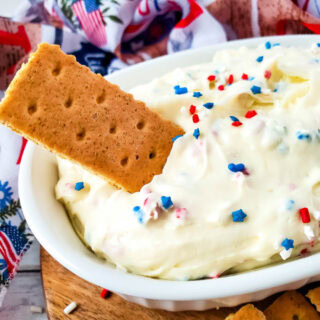 Dipping a graham cracker into cheesecake dip.