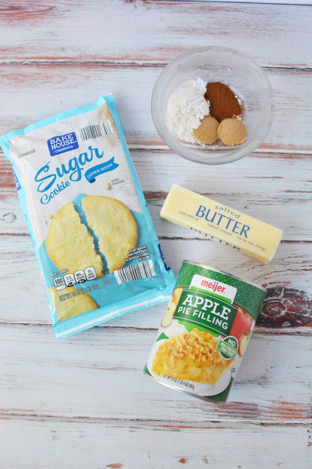 Sugar cookie dough, flour, butter, apple pie filling and more ingredients.