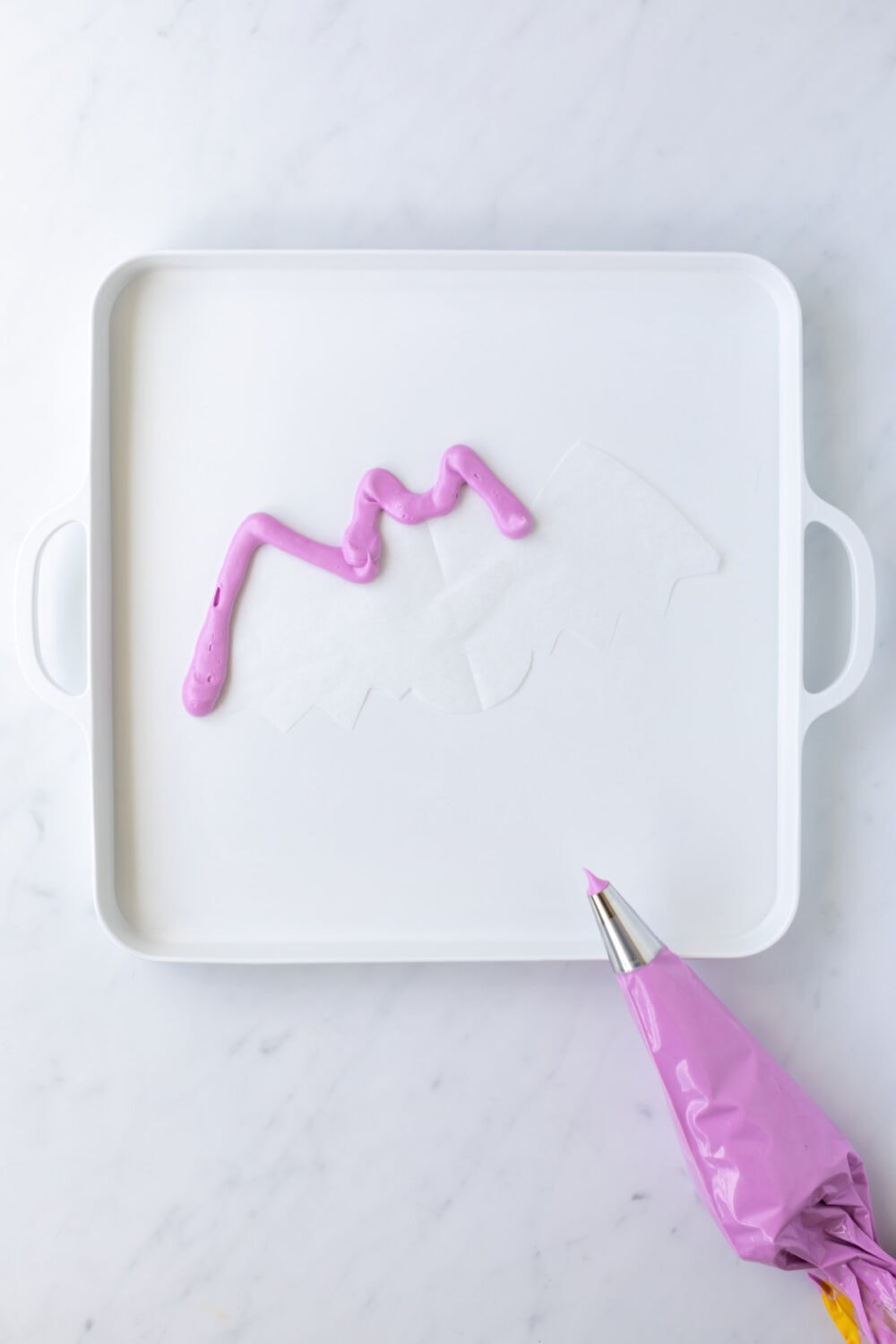 Outlining bat with purple frosting. 