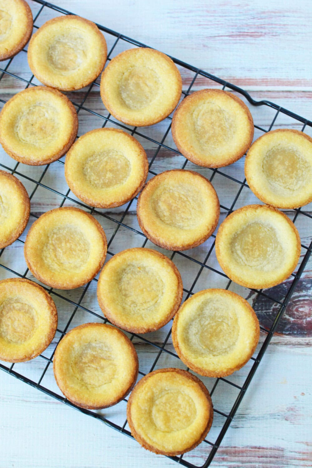 Shaped cookie dough crusts on a wire rack. 
