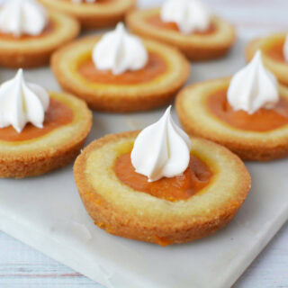 Pumpkin pie filling cookies with whipped cream toppings.