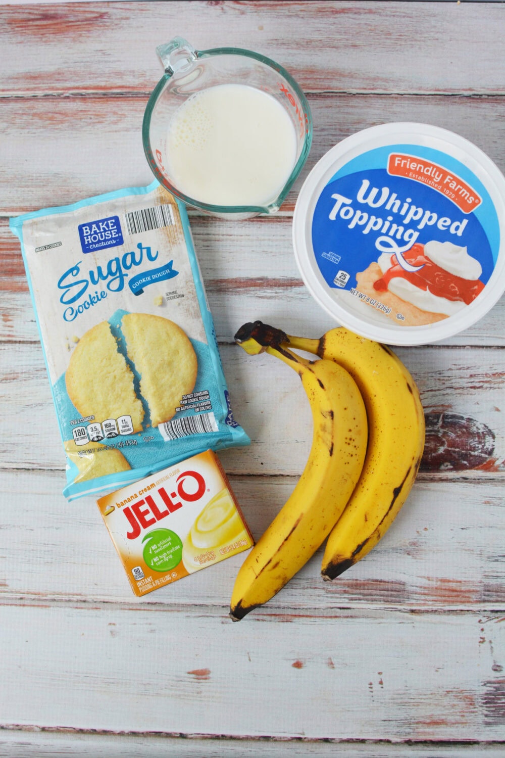 Bananas, banana pudding mix, sugar cookie dough, whipped topping, and milk. 