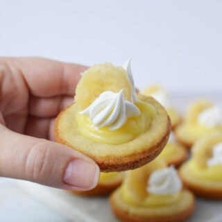 Holding a banana cream pie cookie with whipped cream topping.
