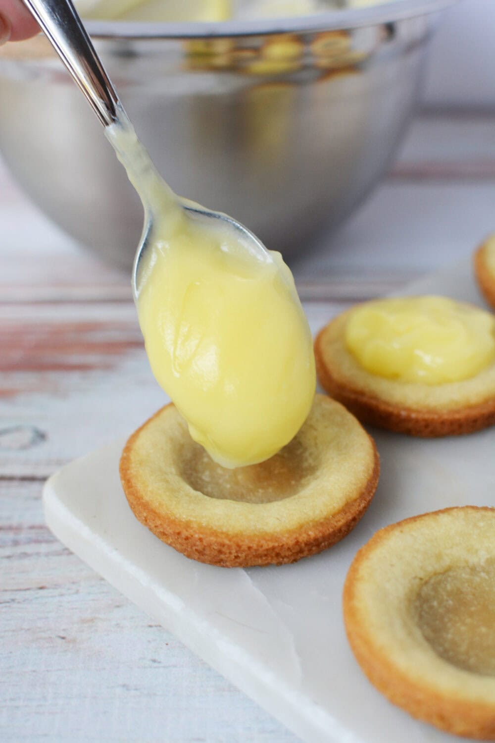 Adding banana cream filling to sugar cookie crusts. 