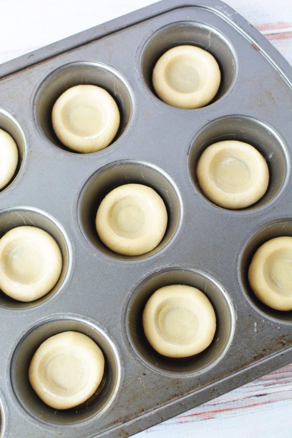 Shaped sugar cookie crusts in muffin tin. 