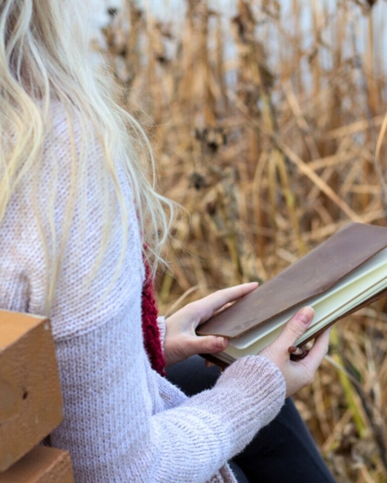 Girl outside with a journal.